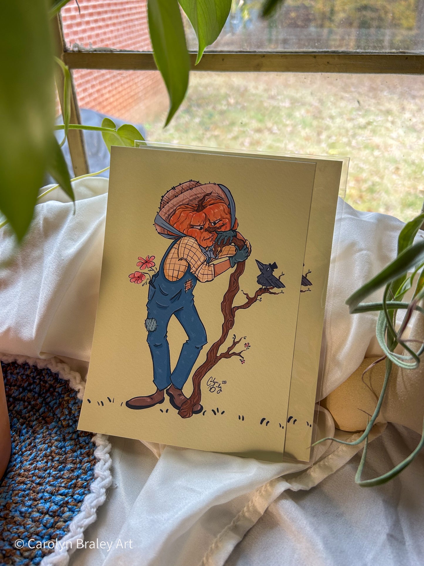 Illustration with scarecrow illustration with a crow on a surface with plants in the background.